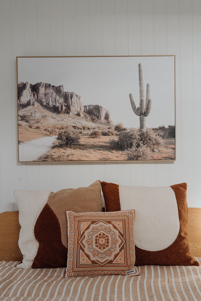 Pillowcase on bed, cactus picture on wall