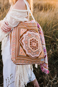 Close up of Girl in grass field wearing orange sofia bag