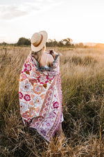 Load image into Gallery viewer, Girl in grass field with pink floral florence throw wrapped around her
