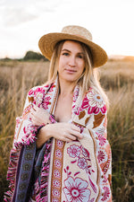 Load image into Gallery viewer, Girl in grass field with pink floral florence throw wrapped around her
