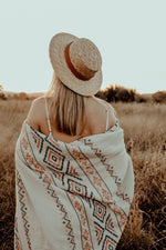 Load image into Gallery viewer, Girl in grass field with white zara throw wrapped around her for warmth
